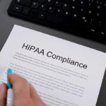 Person looking at a document that says hipaa compliance