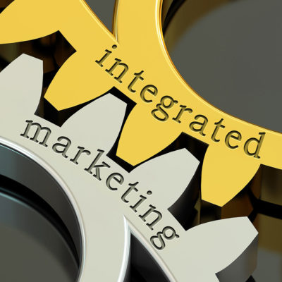 Image: The words 'integrated marketing' etched on gold and silver gears