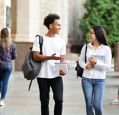 two students walking through a college campus